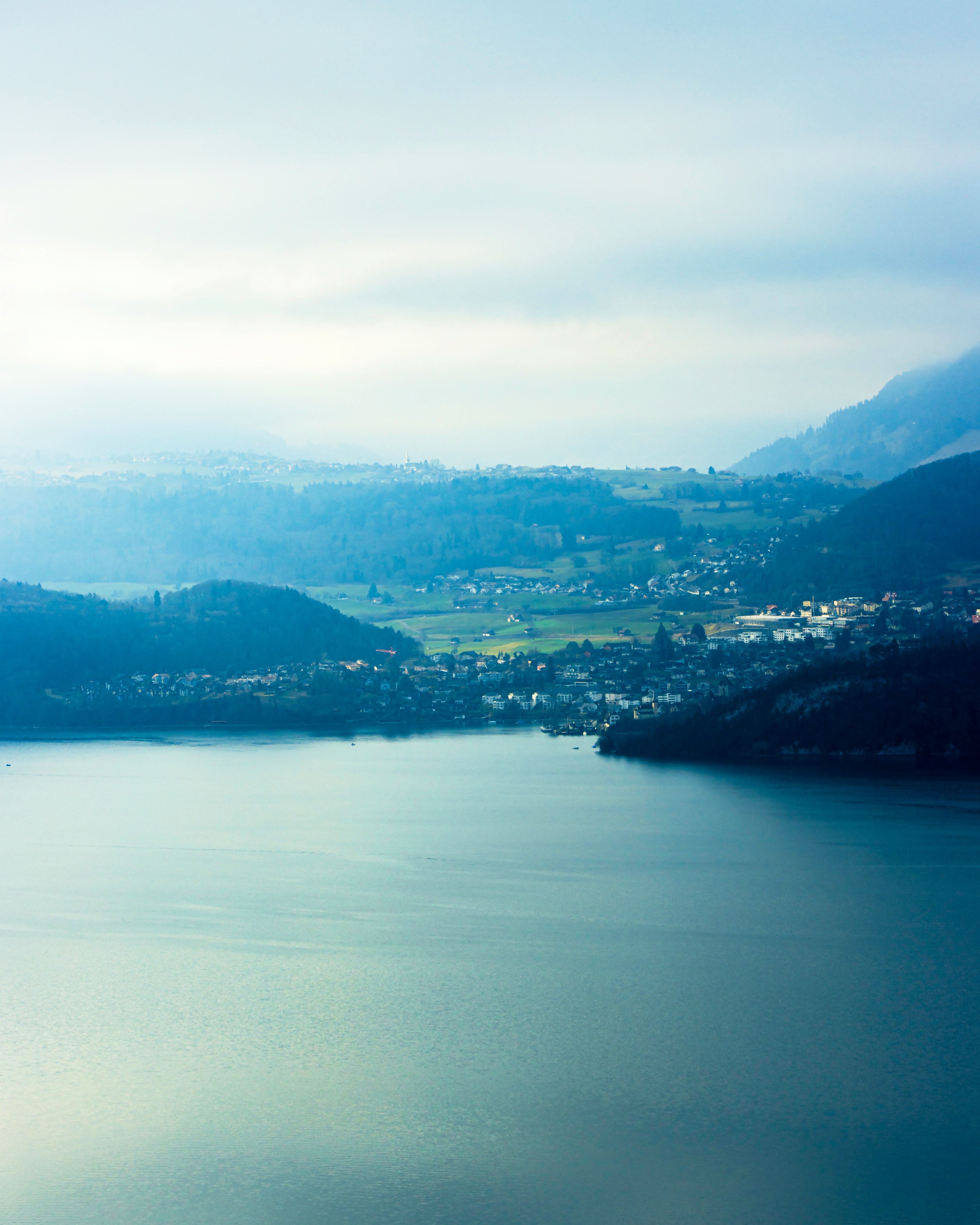 aerial view of green mountains and body of water during daytime